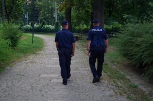 policjanci idą tyłem do fotografującego w Parku Jasnogórskim