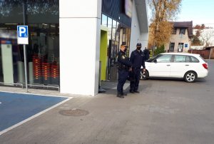 policjanci stoją przed sklepem