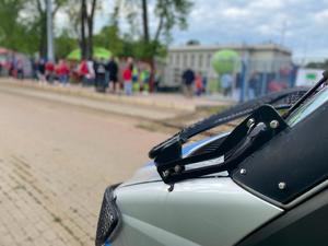 na tle radiowozu kibice idący na mecz piłkarski przed wejściem na stadion