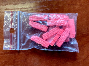 różowe tabletki ekstazy w kształcie ciężarówki zamknięte w woreczku foliowym