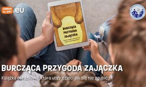 Ulotka informacyjna trzymana w ręce przez dzieci