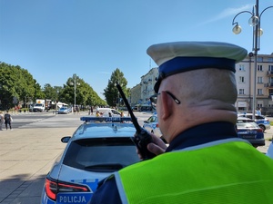 Policjant przy drodze prowadzi korespondencję przez nasobną stację