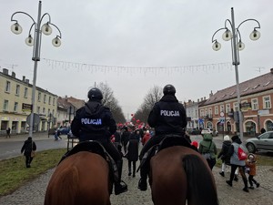 Policjanci na koniach zabezpieczają przemarsz przez miasto