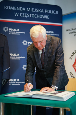 Mężczyzna dokonuje wpisu do książki