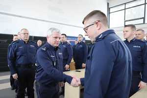 Policjanci witają się w auli na której znajdują się polcjanci