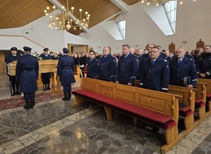 Kierownictwo Policji stoi w kościele przy trumnie