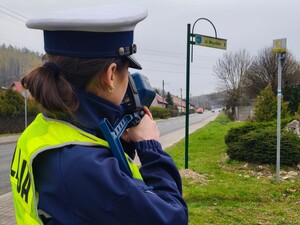 Policjantka radarem mierzy prękość poruszających się pojazdów