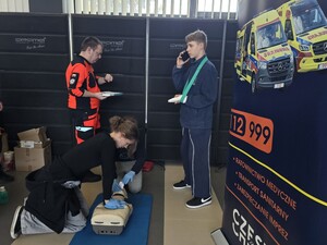 Ratownicy medyczni egzaminują drużynę, która symuluje udzielanie pierwszej pomocy na fantomie